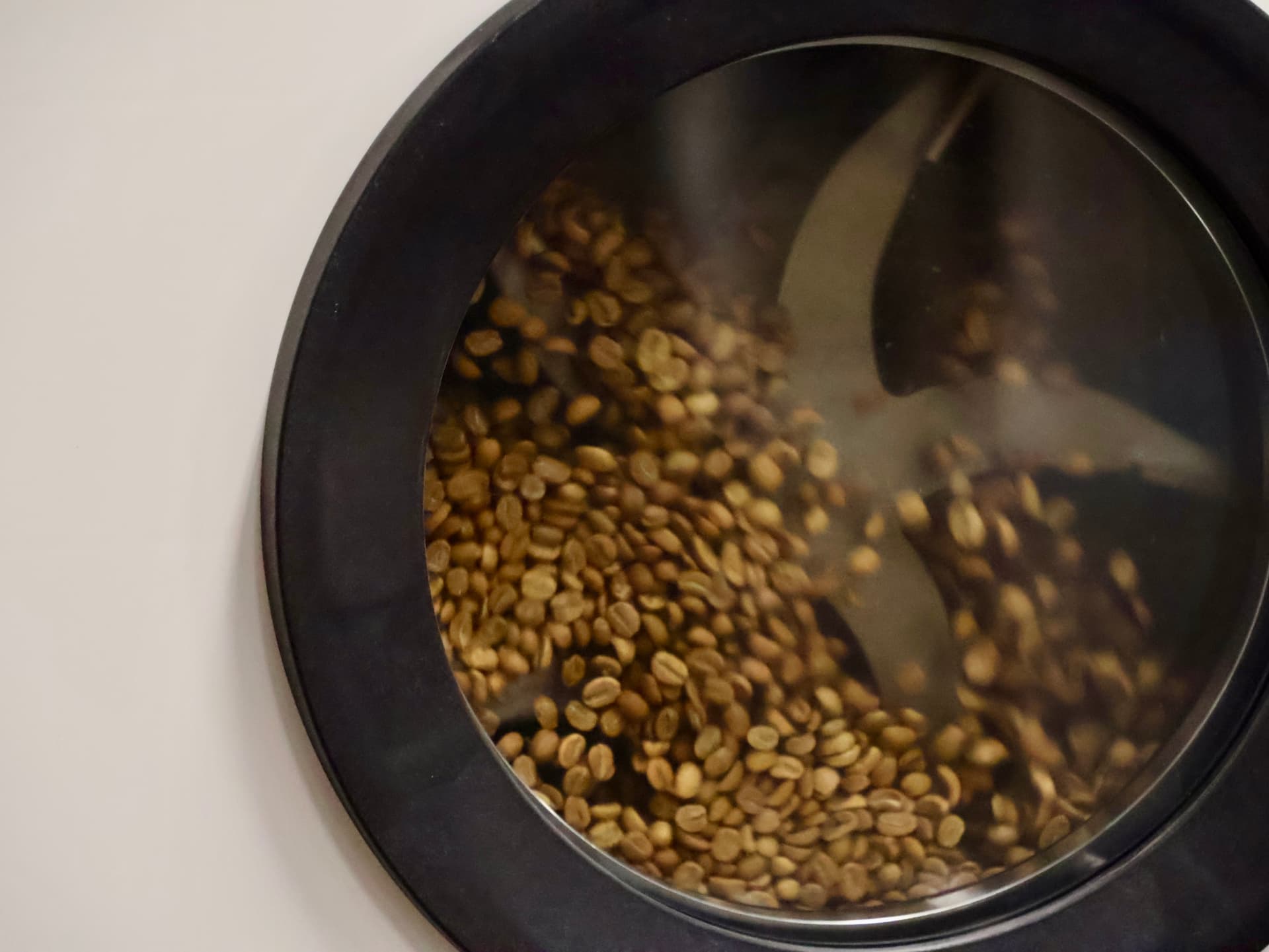 Green coffee beans turning inside the ECHO drum roaster