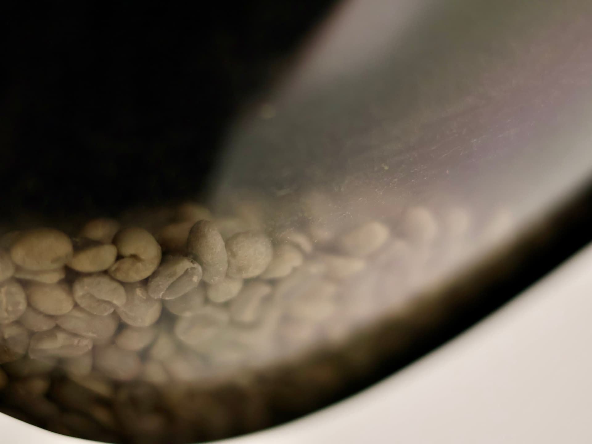 Green coffee beans inside the roaster drum