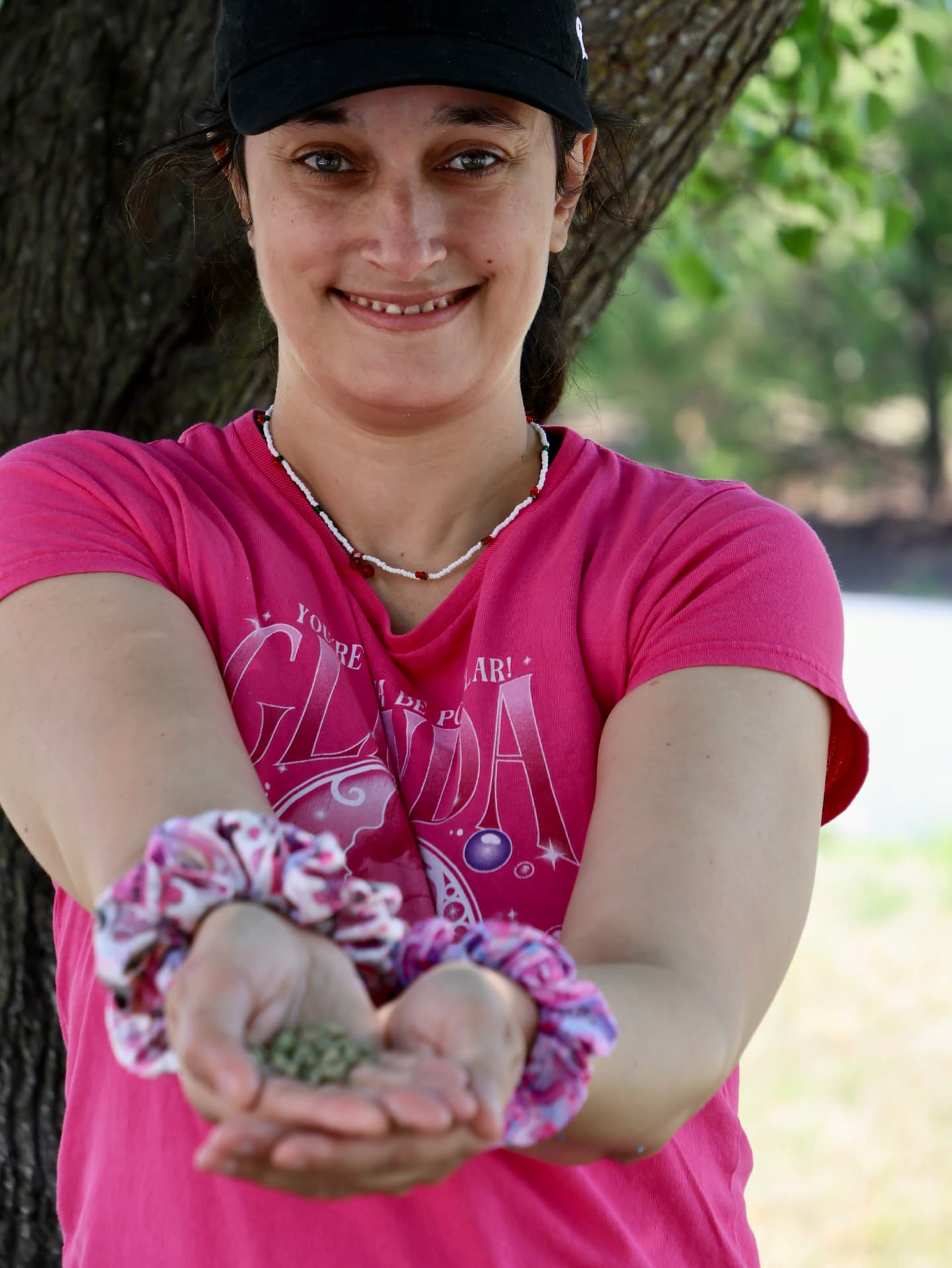 An ECHO team member holding a handful of green coffee beans